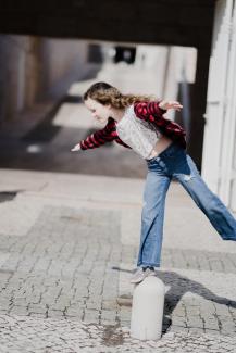 Picture of a girl balancing on one leg on a pedestal